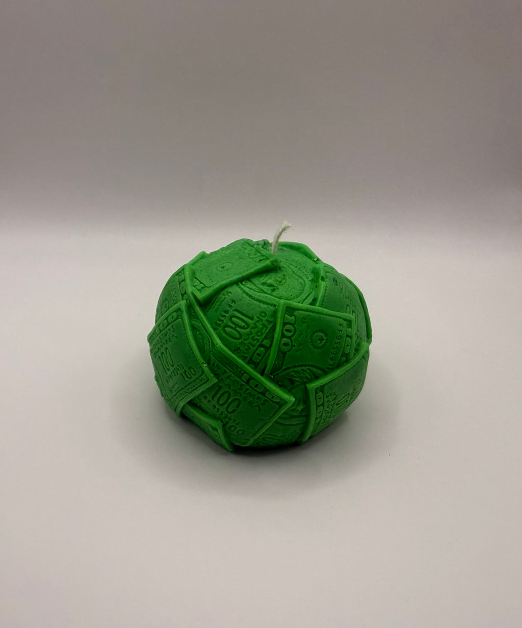 Ball of cash molded candle